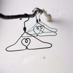 two wire hangers with hearts on them