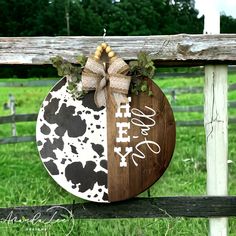 a wooden sign that says happy on it with a bow hanging from the front of it