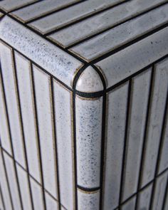 a close up view of the top of a white and black box with lines on it