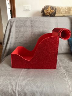 a red object sitting on top of a couch