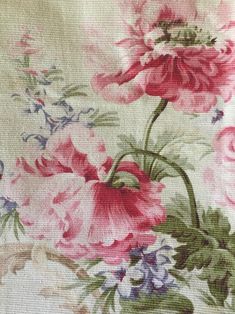 a close up of a flowered fabric with pink and blue flowers on it's side