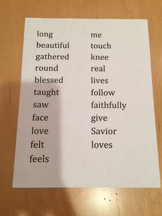 two pieces of paper sitting on top of a wooden table with words written in different languages