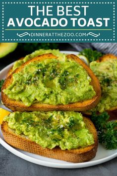 avocado toast on a plate with lemon wedges and parsley in the background