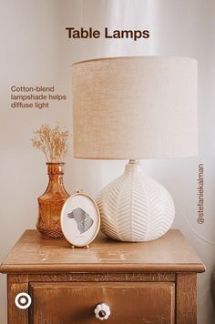 a table lamp sitting on top of a wooden dresser