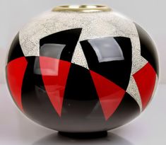 a black and red vase sitting on top of a table