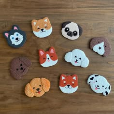 small felt animal magnets sitting on top of a wooden table