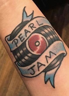 a person with a tattoo on their arm that reads dear jam and has an apple in the barrel