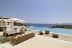 an outdoor lounge area next to a swimming pool