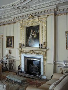 an ornately decorated living room with paintings on the wall