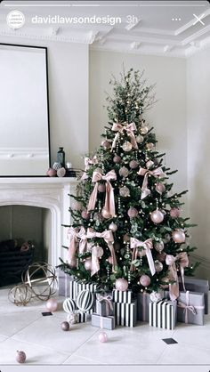 a decorated christmas tree in a living room with pink and black presents on the floor