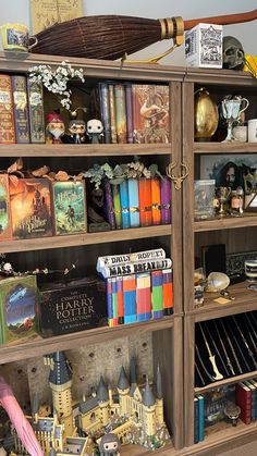 a bookshelf filled with lots of books next to a clock and other items