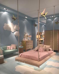 a bedroom decorated in pastel blue and pink with hanging bed, chair, dresser and mirror