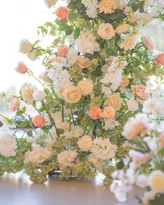 a vase filled with lots of white and pink flowers