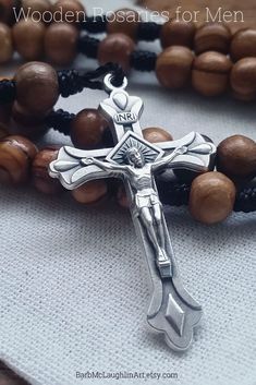 a wooden rosary with a cross on it and the words, wood rosary for men