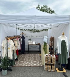 a tent with clothes on display in front of it