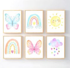 four watercolor paintings on the wall, each with different shapes and sizes of butterflies