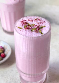 two glasses filled with ice cream and raspberries