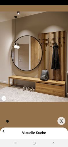 a room with a mirror, bench and coat rack