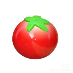 a red ball with a green starfish on it's top, against a white background