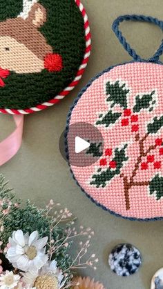 cross - stitch ornaments are displayed on a table