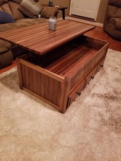 a wooden coffee table with drawers on top