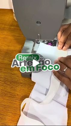 a person is using a machine to cut paper on a piece of white fabric with the words family artifico emfoco