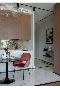 a dining room table with two chairs next to it