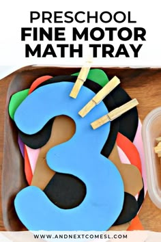 the number three is made out of cookies and sits on a tray with pre school fine motor math trays