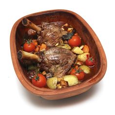 a wooden bowl filled with meat and vegetables