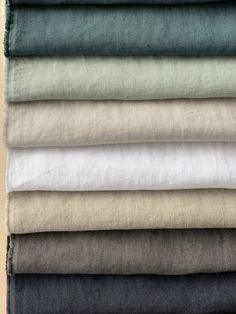 six different colored linens stacked on top of each other in various sizes and colors