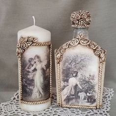 two candles with pictures on them sitting on a lace doily next to each other