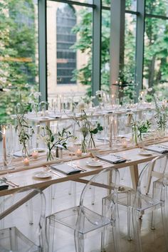 the tables are set up with clear chairs