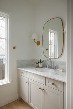 Bathroom with cream cabinets, brass accents, and granite countertop. Mushroom Bathroom Cabinets, Cream Cabinets Bathroom, White Countertops Bathroom, Cream Bathroom Cabinets, Bathroom Mixed Metals, Bathroom Vanity Color Ideas, Cream Bathroom Vanity, Mixed Metals Bathroom, Mixing Metals In Bathroom