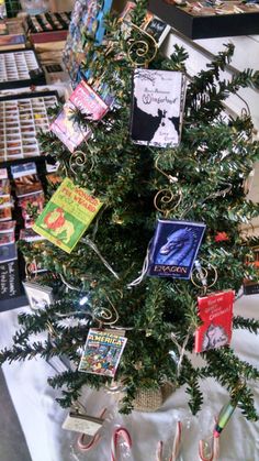 a christmas tree decorated with books and candy canes is on display in a store