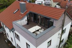 an aerial view of a house with red roof tiles