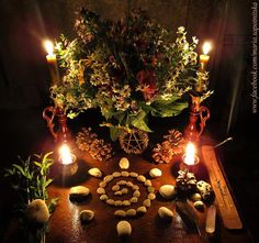 a table topped with lots of food and candles