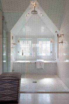 a large white bathroom with a walk in shower