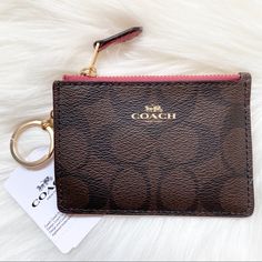 a coach wallet with a keychain on top of it