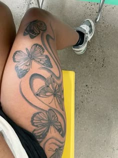 a woman's legs with butterfly tattoos on them