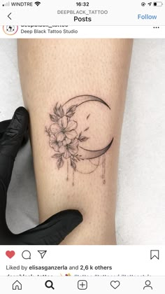 a woman's leg with a flower and crescent tattoo on the left side of her thigh