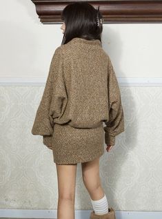 Cozy oversized sweater in a heathered brown wool blend. Features a distinctive dark brown X-pattern on the chest. High cowl neck for warmth. Long, loose sleeves for comfort. Lower portion has decorative side buttons for added style. Perfect for casual autumn/winter wear or rustic-inspired looks. Pair with leggings or skinny jeans for a comfy-chic ensemble. Model info Height: 160cm Weight: 42kg Wearing size: M Casual Brown Sweater Dress, Brown Turtleneck Cardigan For Winter, Brown Long Sleeve Sweater Dress For Winter, Brown Wool Sweater For Fall, Brown Knit Long Sleeve Sweater Dress, Brown Relaxed Fit Sweater For Loungewear, Brown Long Sleeve Chunky Knit Outerwear, Brown Knit Sweater Dress For Winter, Oversized Long Sleeve Sweater Dress For Winter