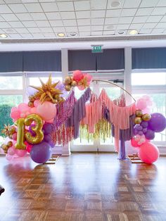 balloons and streamers decorate the entrance to an event