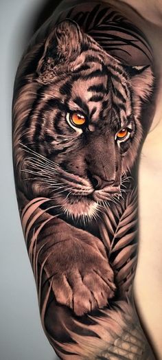 a man's arm with a tiger tattoo on it, and an orange eye