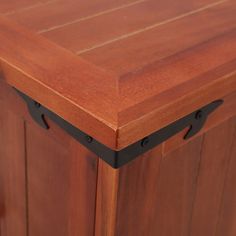 a close up of a wooden cabinet with black hardware on the door and bottom section