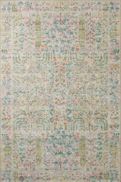 an area rug with various colors and designs on the ground, including trees in pastel tones