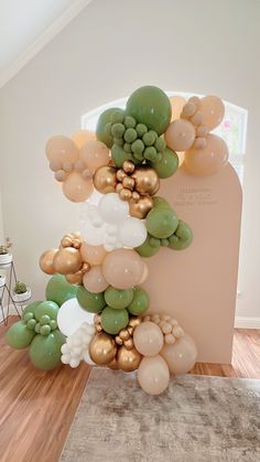 balloons are stacked on top of each other in the shape of a number one, with gold and green accents