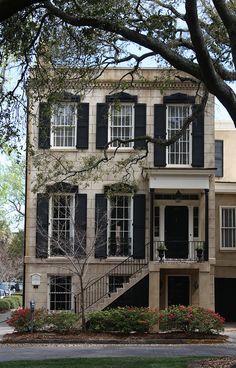 an old house with black shutters and windows