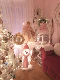 a living room decorated for christmas with white and pink decorations on the tree, teddy bear figurines and other ornaments