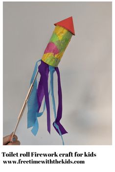 a hand holding a colorful paper kite with ribbons on it's end and the words toilet roll firework craft for kids below