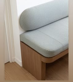 a close up of a bed with a wooden headboard and foot board on it